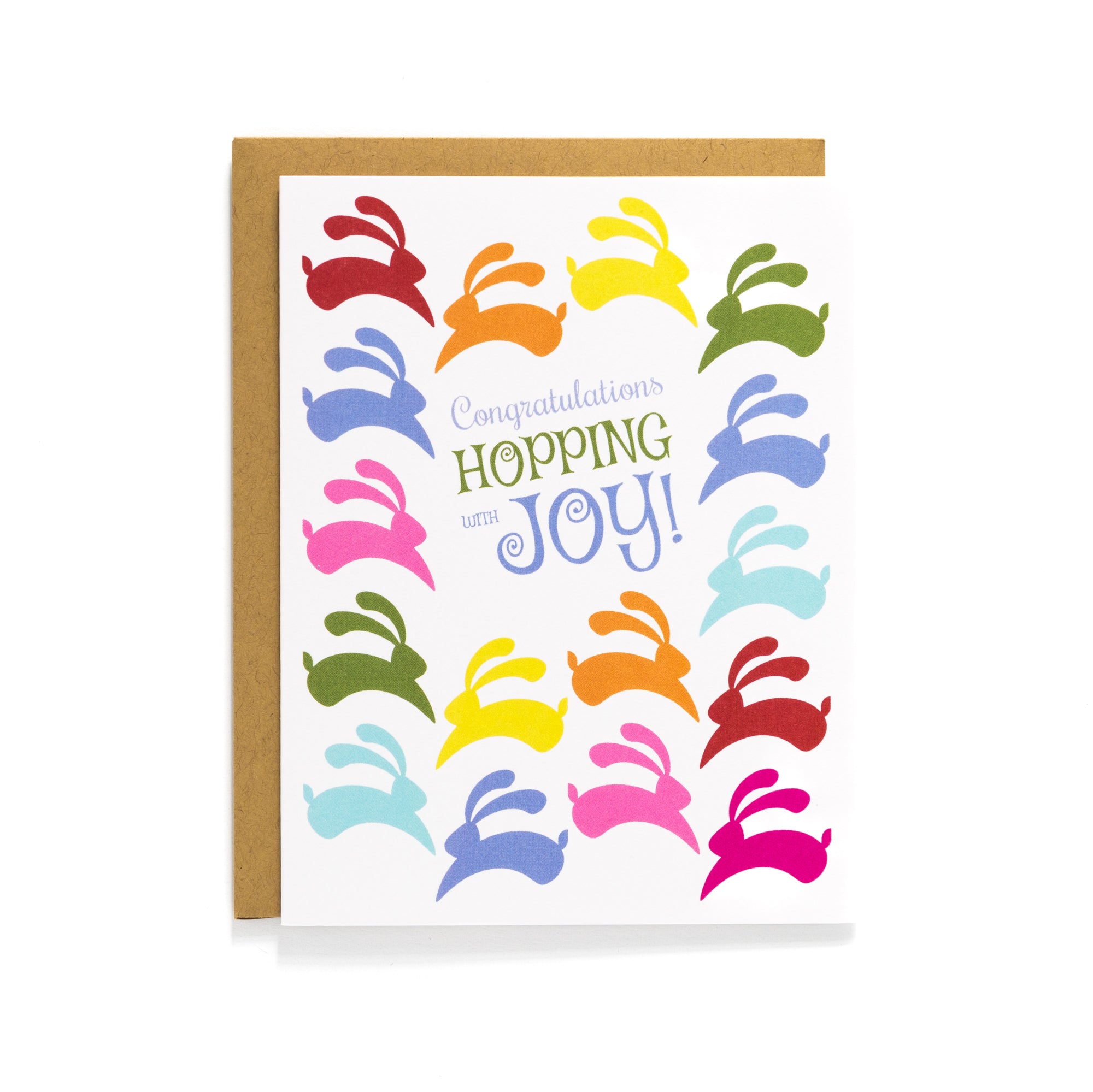 Colorful bunny pattern with text "Congratulations Hopping Joy!" on a bright greeting card and a kraft envelope background