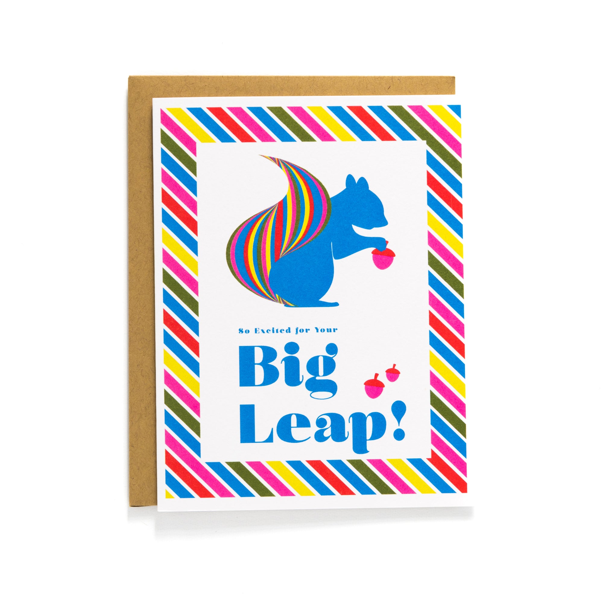 Greeting card with a blue squirrel holding acorns and rainbow-striped tail bordered by colorful diagonal stripes.