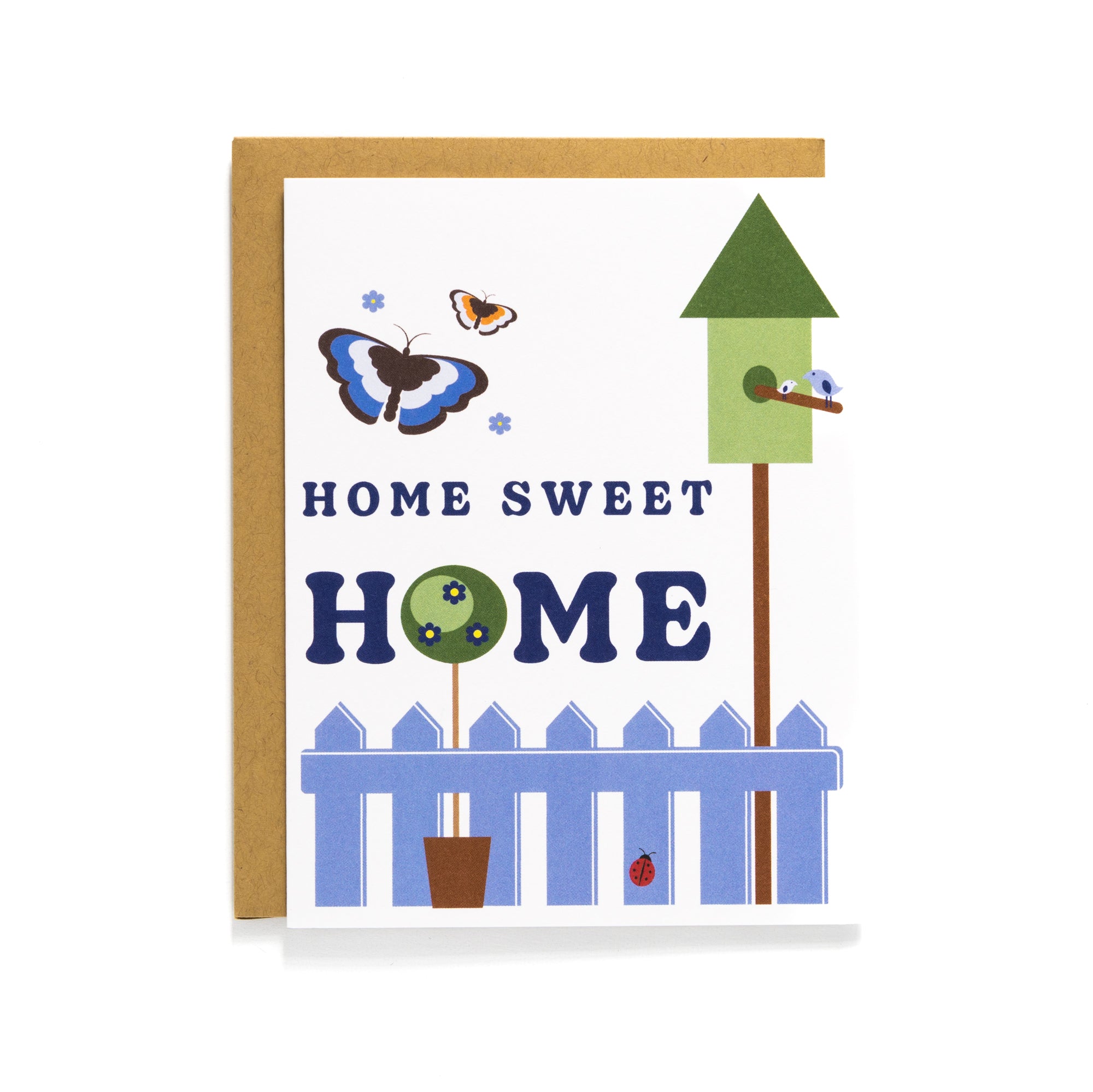 Home Sweet Home card with butterflies, birdhouse, white picket fence, and garden scene, blank inside with kraft envelope.