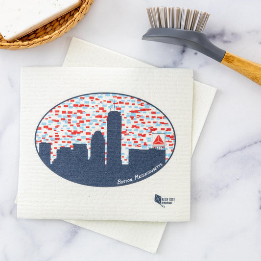 Boston Skyline Swedish Dishcloth featuring a navy blue silhouette of Boston's downtown buildings against a white background with scattered red and blue geometric patterns, highlighted by the distinctive Citgo Sign logo in red. Eco-friendly cellulose dishcloth perfect for sustainable cleaning.