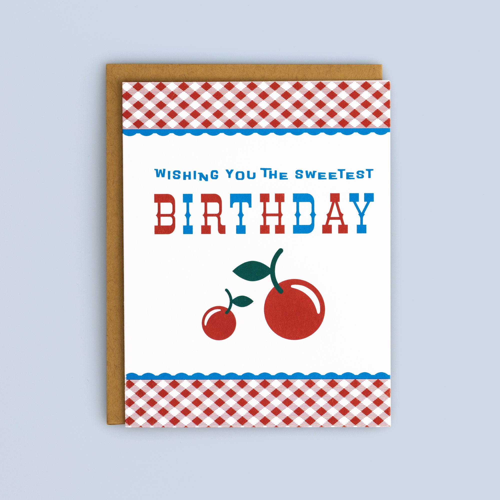 Flat birthday card with red cherries and red gingham border on white background, includes kraft envelope.