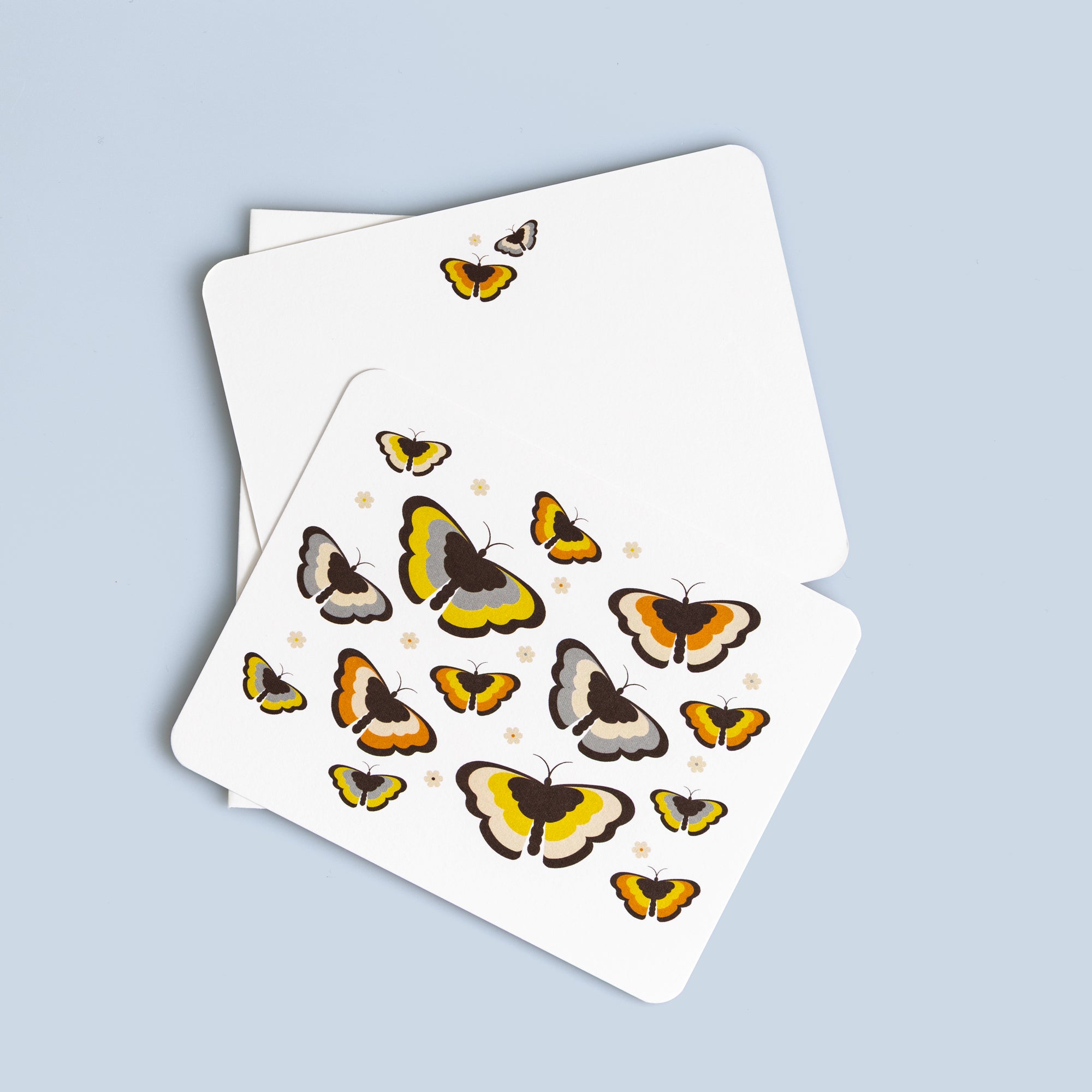 Set of six flat butterfly cards featuring colorful retro-style butterflies with coordinating white envelopes on a blue background