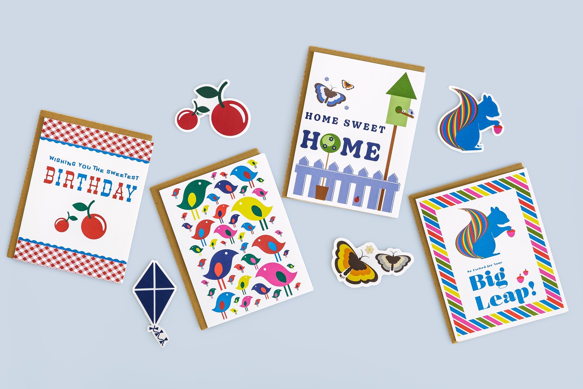Colorful mix of greeting cards and stickers for all occasions celebrating birthday, a new home, a new adventure and more.