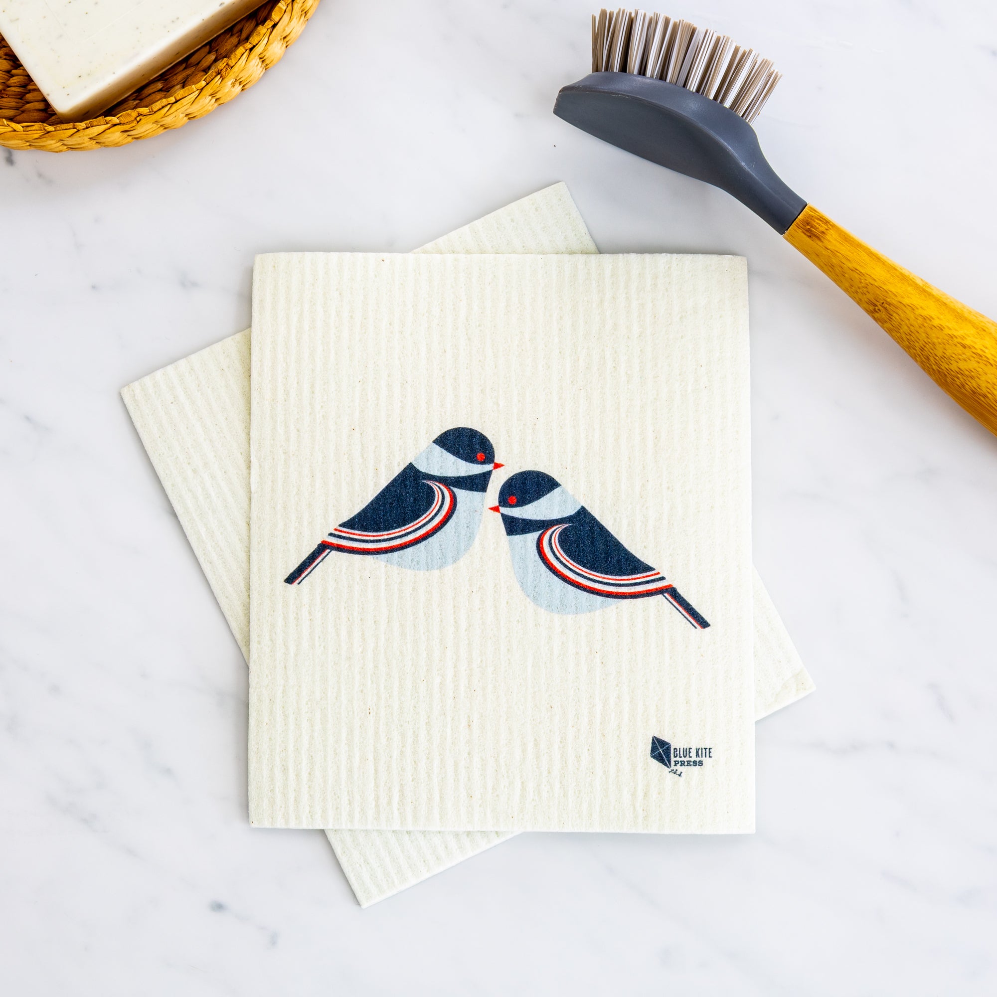 Chickadee Swedish Dishcloth with modern birds design, eco-friendly reusable alternative to paper towels on white surface.