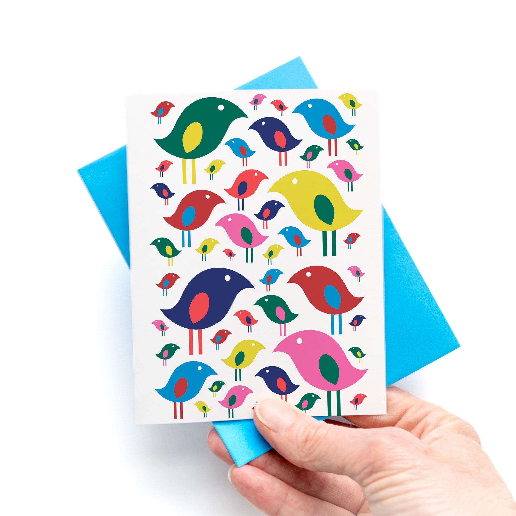 Bright Birds Card with colorful playful bird pattern, blank inside, held over blue envelope for joyful celebrations.
