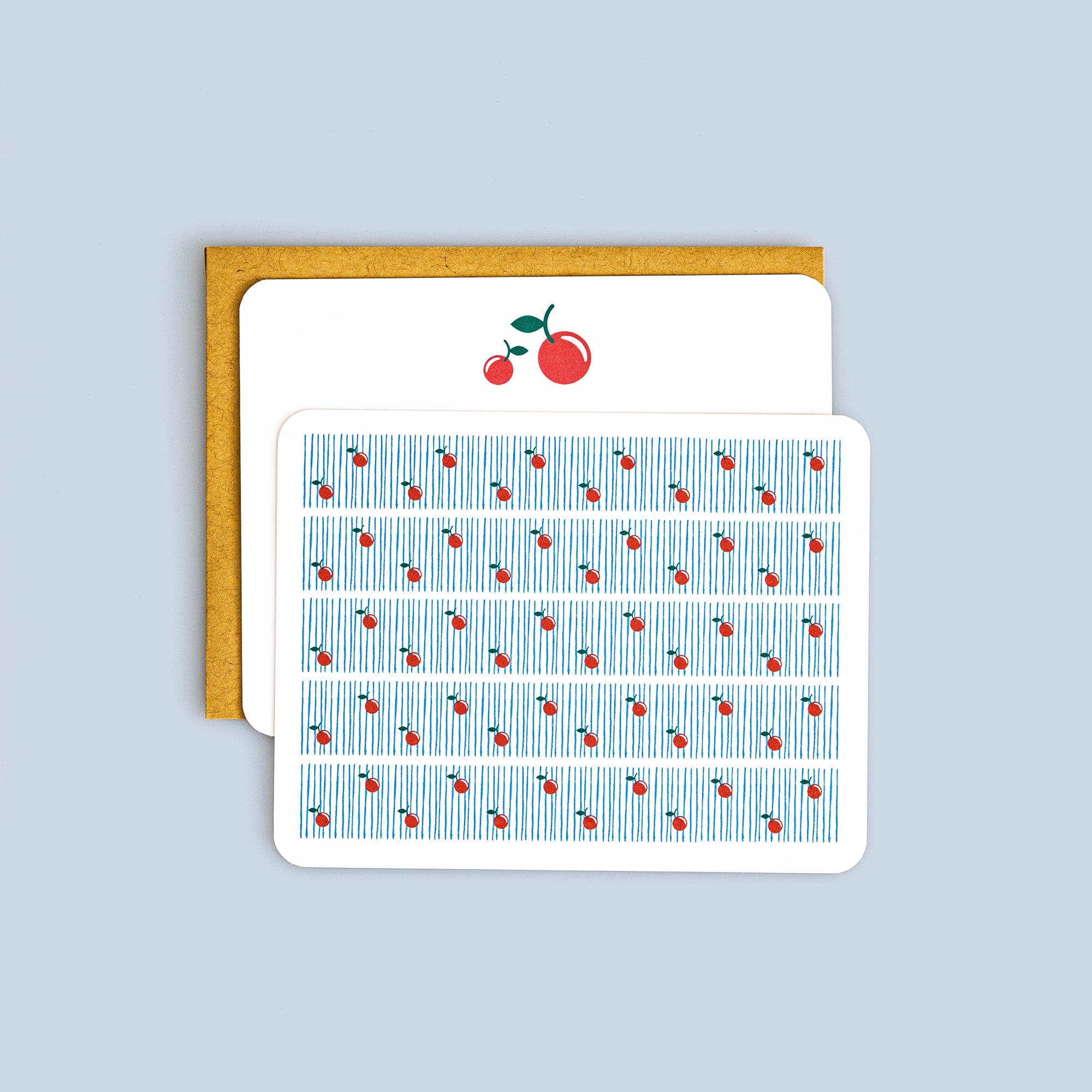 Set of 8 flat cards featuring retro cherry pattern with coordinating kraft envelopes on pale blue background