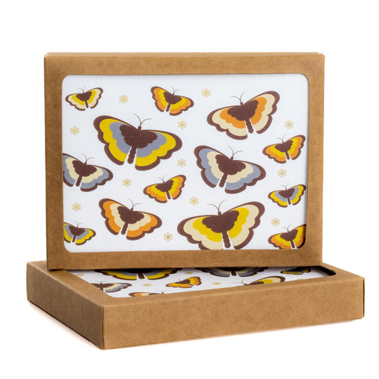 Butterfly notecard set with 70s retro design, featuring colorful butterflies on white background. Eco-friendly kraft paper box contains 8 cards and envelopes for personal messages.