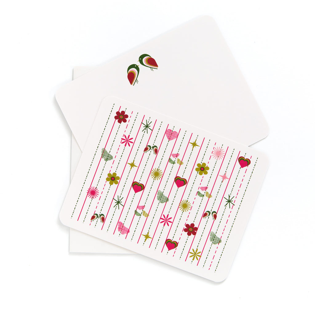 Pink Tiki flat card with colorful mid-century modern floral and heart pattern, accompanied by a matching envelope.