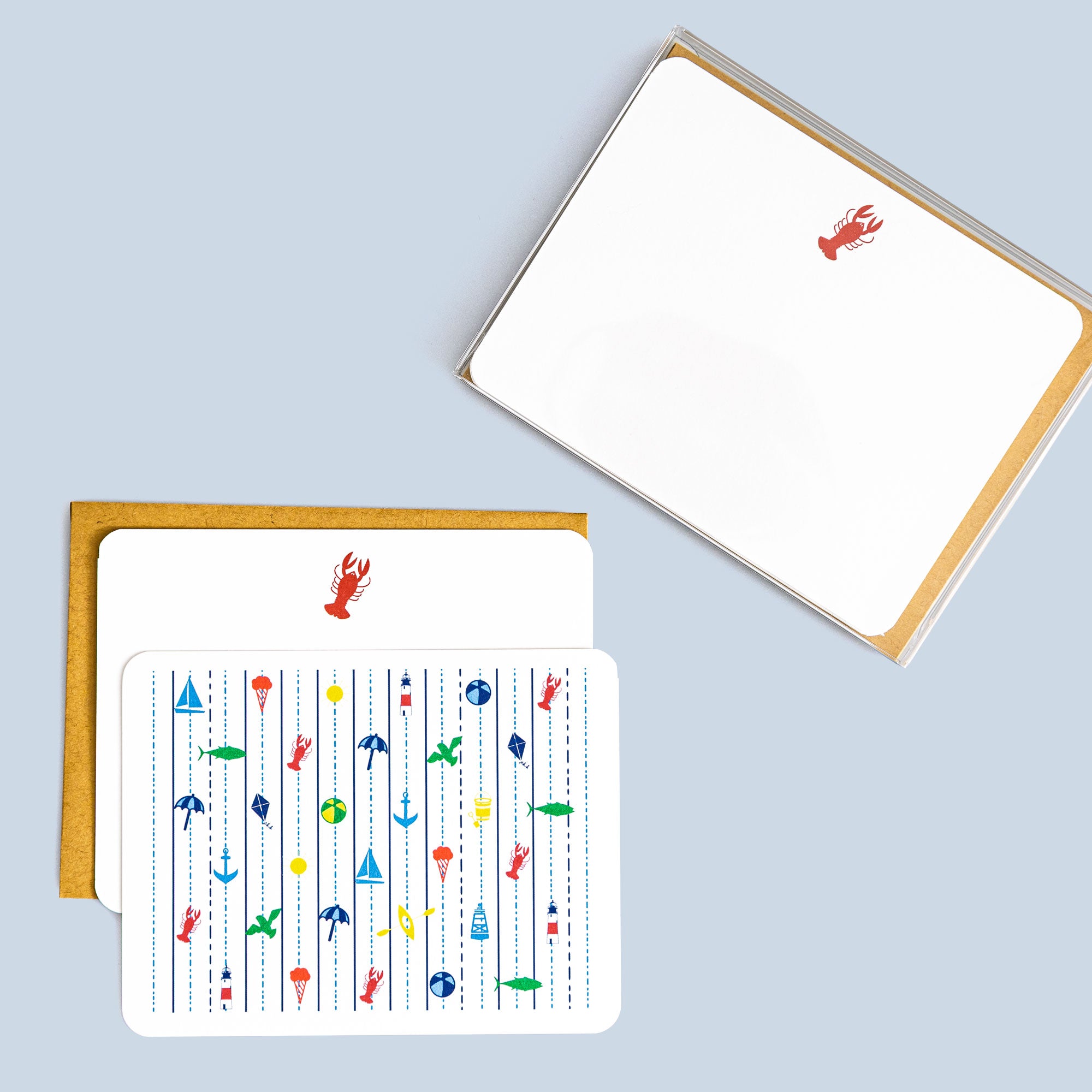 Set of seaside flat cards with nautical icons like lobsters, anchors, and fish, paired with kraft envelopes.