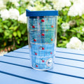 Cherry Classic Tervis Tumbler 16 oz with vintage cherries design, keeps drinks hot or cold, blue lid on outdoor table.